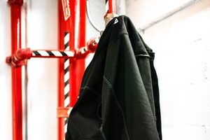black coat hanging on red coat raack