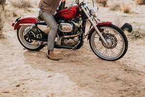 man riding red cruiser motorcycle